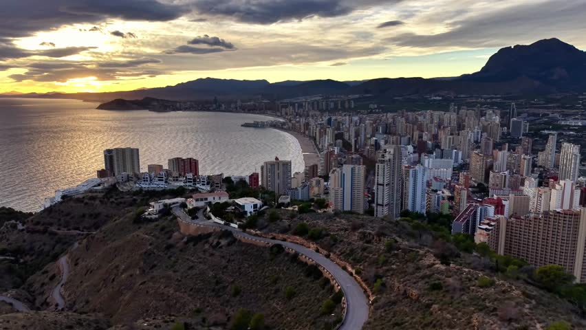 scenic coastal journey, photographer captures sunset drive, curved seaside highway leads to sunset
