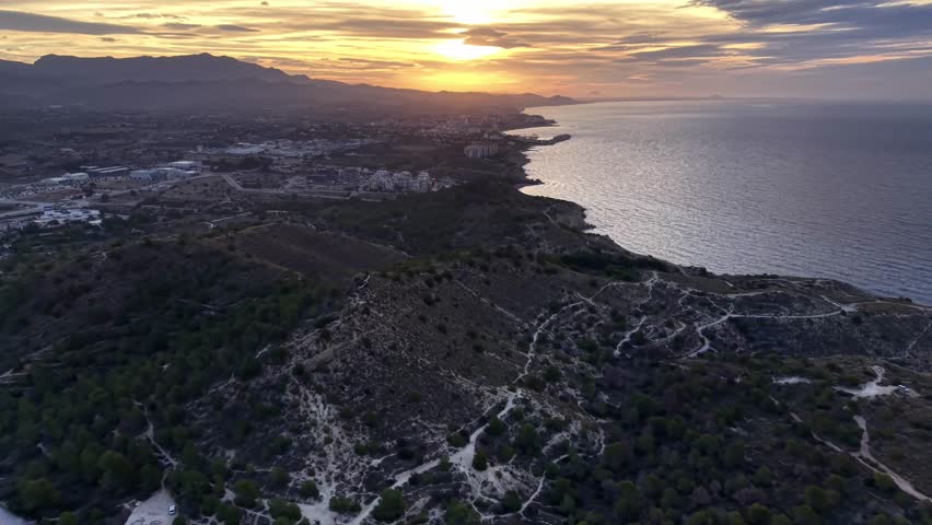 evening coastal panorama, dusk over seaside landscape, sunset view of coast with calm waters