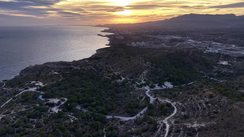 serene sunset over cliffs and trees, calm twilight view with forests and rugged coastlines