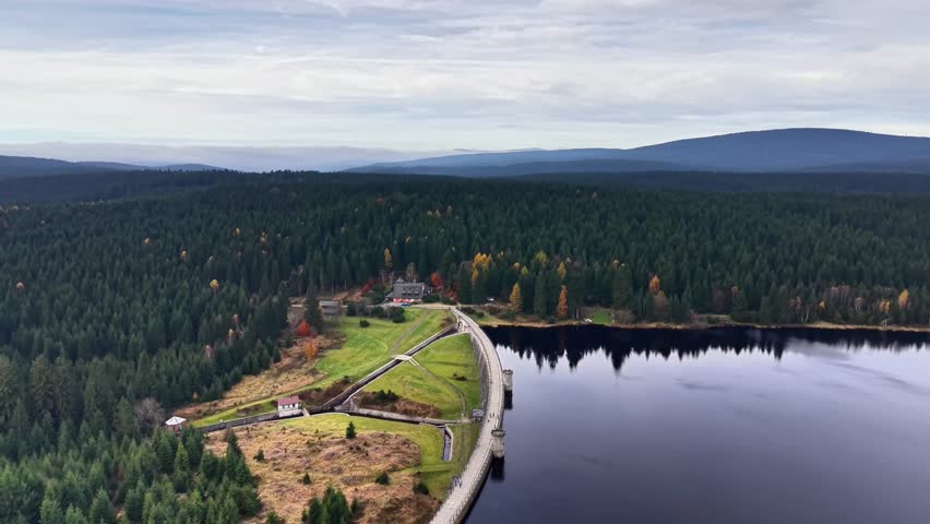 Scenic dam landscape, Calm reservoir surrounded by lush greenery, Elevated view of tranquil dam with forested