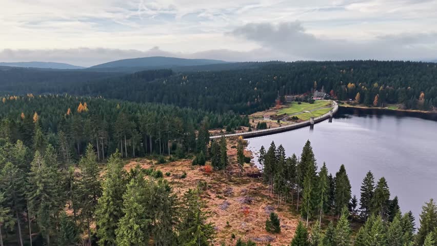 drone survey of natural surroundings, vast moorland with reflective waters and rugged terrain