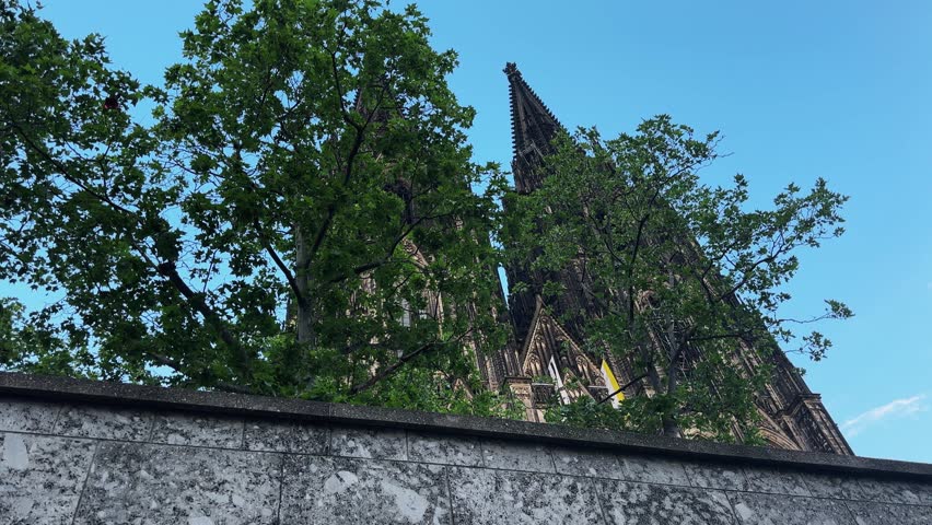 Cologne Dom cathedral seen from below with blue sky. Cologne Cathedral, or Kolner Dom, is the main landmark of Cologne and a catholic church in Germany.