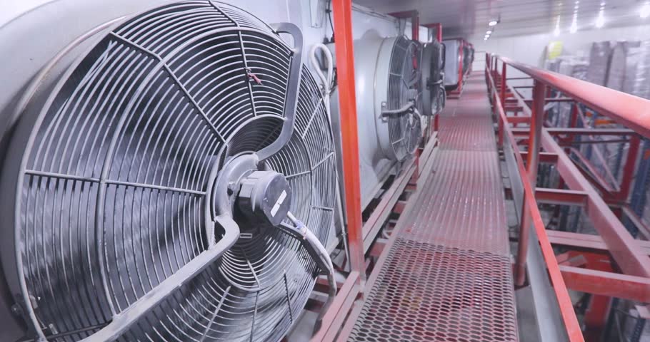 Large multi-level low temperature warehouse, inside. Frozen food and ice cream storage in a modern cold storage warehouse. Industrial Air Conditioner working, close-up.