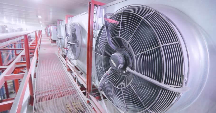 Industrial Air Conditioning Units in a Large cold Warehouse for Efficient Climate Control Solutions. Large multi-level low temperature warehouse, inside. Industrial Air Conditioner, close-up.
