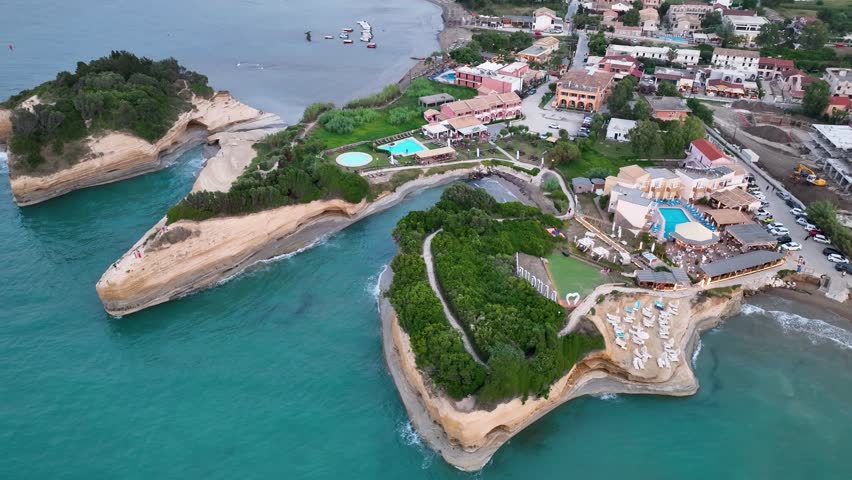 High-angle aerial drone revealing the famous Canal d'Amour, the tourist resorts, and the village of Sidari, Corfu, Greece