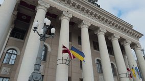Majestic government building scene, Historical neoclassical structure with flags and tall pillars - Powered by Shutterstock - Get 15% off with code: PIKWIZARD15