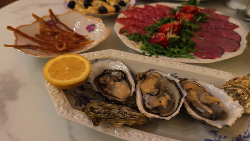 Fresh oysters served with lemon, Elegant presentation of raw oysters with herbs and citrus wedges
