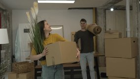 laughing couple in love hold box and carpet on relocation day, feel happy, enjoy first day at their own house or flat. Independence, life changes - Powered by Shutterstock - Get 15% off with code: PIKWIZARD15