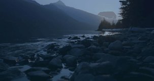 Rocky shoreline showing faint overlay fading in, progress bar filling for receiving encrypted data. Lakeside, mountains, forest, bluehour, tranquil, reflective, doubleexposure - Powered by Shutterstock - Get 15% off with code: PIKWIZARD15