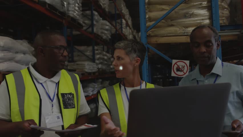 Warehouse team using laptop, center operator starting network overlay covering team, checking stock. Inventory, logistics, planning, collaboration, analytics, digital, facility - Powered by Shutterstock - Get 15% off with code: PIKWIZARD15