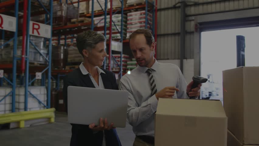 Logistics team inspecting laptop man scanning boxes overlay expanding over shelves for inventory. Warehouse, collaboration, scanner, computer, packaging, network, analytics