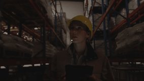 Woman warehouse worker tapping tablet, causing HUD network growth, covering racks, monitoring stock. Device, helmet, highvisibility, logistics, analytics, industrial, pallets - Powered by Shutterstock - Get 15% off with code: PIKWIZARD15