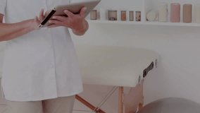 Clinician tapping tablet, initiating patient data update, causing falling binary digits over clinic. Medical, healthcare, professional, stock, advertising, digital, overlay - Powered by Shutterstock - Get 15% off with code: PIKWIZARD15