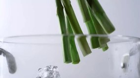 asparagus falling into a clear glass pot - Powered by Shutterstock - Get 15% off with code: PIKWIZARD15