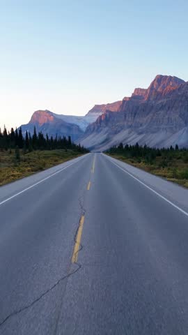 Scenic Highway Leading to Majestic Mountains at Sunrise in Banff National Park, Alberta, Canada