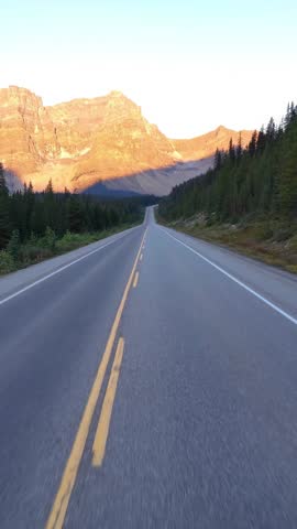 Scenic Drive Through Banff National Park, Alberta, Canada at Golden Hour on an Empty Road