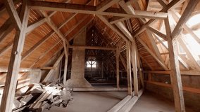 Slow push-in shot through the wooden rafters and exposed beams of an unfinished attic or loft space. The scene is brightly lit by a small window, showing a renovation or construction project. - Powered by Shutterstock - Get 15% off with code: PIKWIZARD15