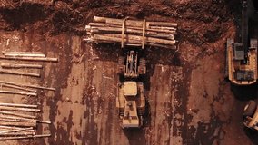 Aerial view of a timber yard filled with stacked logs, heavy machinery, and industrial equipment. - Powered by Shutterstock - Get 15% off with code: PIKWIZARD15