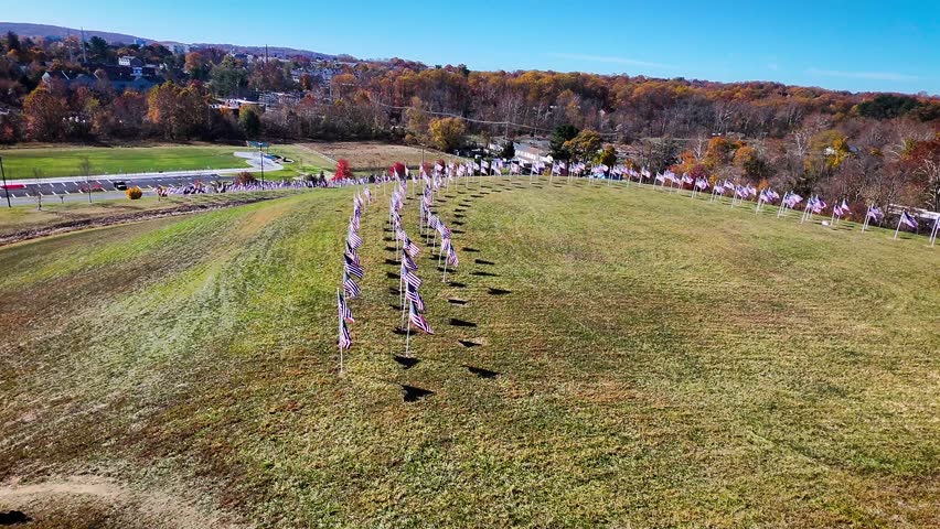 Field of American Flags fpv drone hillside autumn in Delaware