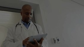 Male doctor using tablet in clinical environment, showcasing user-profile network graphics. Healthcare, telemedicine, technology, professionalism, connectivity, innovation, digital - Powered by Shutterstock - Get 15% off with code: PIKWIZARD15