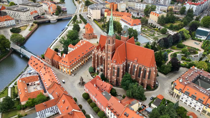 Aerial drone view of Wrocław city on the Oder River in western Poland, highlighting historic buildings, bridges, and scenic riverside landscapes.