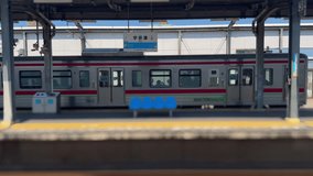 Inside Utazu Station, Japan, the train slowly departs from the platform, with blue seats and clear signs outlining a tranquil railway commuting scene. - Powered by Shutterstock - Get 15% off with code: PIKWIZARD15