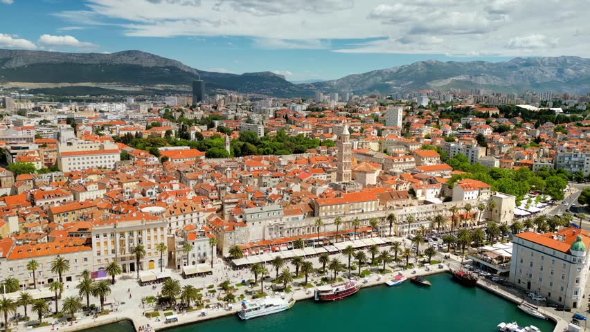 Aerial drone view of buildings along the Adriatic Sea in Dubrovnik, Croatia, showcasing historic architecture, coastal cityscape, and scenic Mediterranean views.