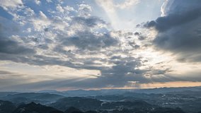 Dramatic sunbeams breaking through storm clouds over mountain landscape, creating divine rays of light and atmospheric Tyndall effect in moody sky - Powered by Shutterstock - Get 15% off with code: PIKWIZARD15