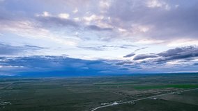 Aerial view of vast Qinghai grassland plateau with dramatic cloudy sky and winding road, perfect for time lapse photography and tourism promotion material - Powered by Shutterstock - Get 15% off with code: PIKWIZARD15