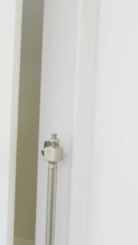 Animation of envelope icon in circles over senior smiling woman opening door. Digital composite, multiple exposure, business, abstract, message, welcoming and retirement concept.