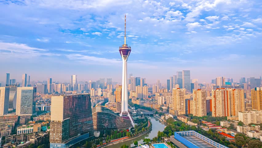 Stunning aerial panorama of Chengdu city skyline with iconic TV tower landmark rising above modern CBD skyscrapers under dramatic cloudy sky in Sichuan, China.