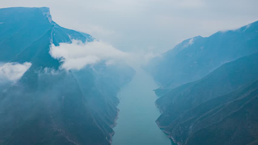 Magnificent three gorges time lapse view overlooking Yangtze River with dramatic mountains and clouds in China