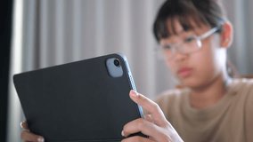 Asian girl studying online using tablet computer at home - Powered by Shutterstock - Get 15% off with code: PIKWIZARD15
