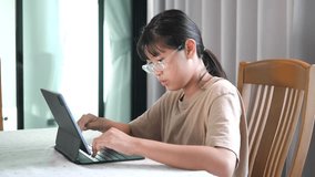 Asian girl studying online using tablet computer at home - Powered by Shutterstock - Get 15% off with code: PIKWIZARD15