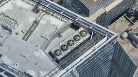 Top-down view of ventilation fans spinning on the roof of a skyscraper - Powered by Shutterstock - Get 15% off with code: PIKWIZARD15