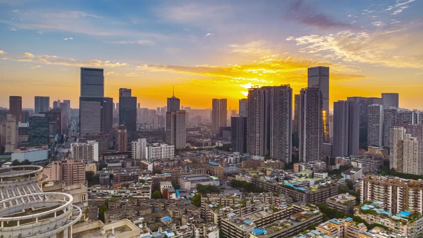 Stunning aerial view of Chengdu city skyline at golden hour with modern skyscrapers and urban landscape bathed in warm sunset light over China