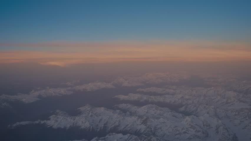 Aerial View of Snowy Mountains at Sunset