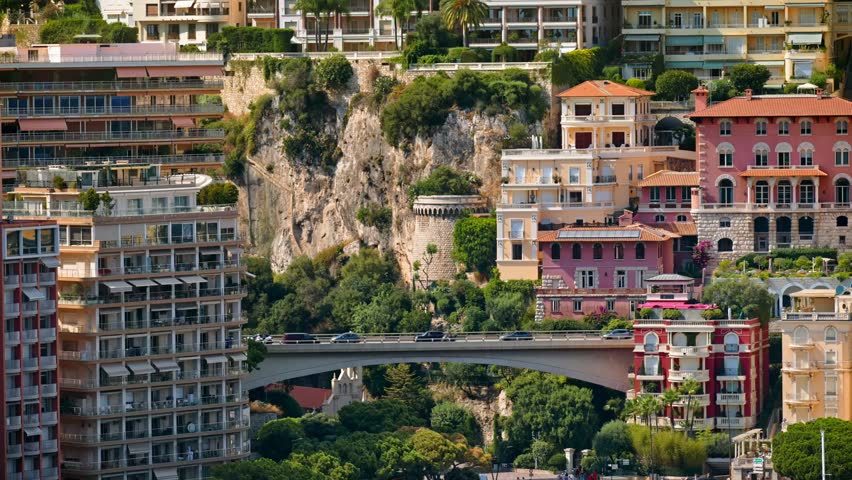 Aerial view of Monaco skyline in daylight, showcasing luxurious cityscape, waterfront, and Mediterranean urban charm.