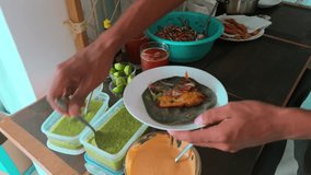Man Putting Sauce On His Baja-style Fish Tacos. - closeup shot - Powered by Shutterstock - Get 15% off with code: PIKWIZARD15