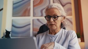 Confident senior businesswoman in glasses on laptop video conference call - Powered by Shutterstock - Get 15% off with code: PIKWIZARD15