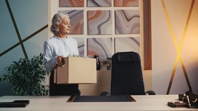Happy senior businesswoman moving into new office, unpacking her belongings - Powered by Shutterstock - Get 15% off with code: PIKWIZARD15