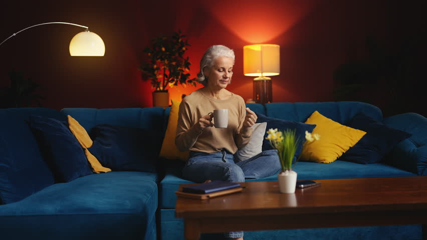 Beautiful senior woman taking vitamins with water, beauty and wellness