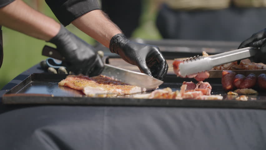 Traditional Argentinian barbecue with chef slicing grilled pork and sausages, culinary skill and heritage