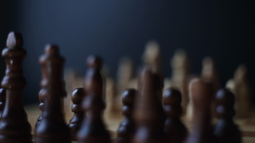 Chess, dynamic video of chess pieces on a rotating chessboard, the concept of confrontation between black and white. intellectual play, willingness to make the first move