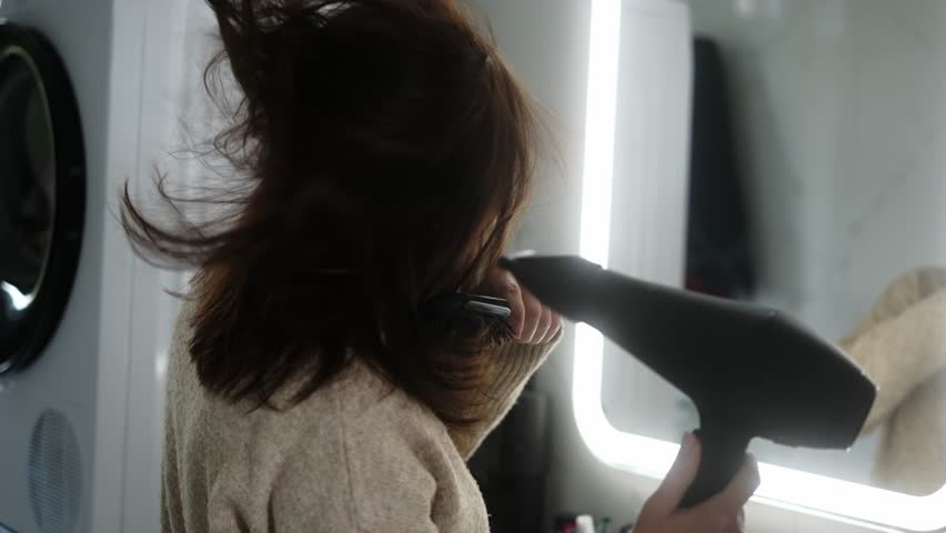 Girl Drying Hair With A Hairdryer In Front Of The Mirror In Slow Motion