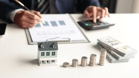 Investing in Real Estate, Real estate agent or investor, calculating or analyzing financial data related to property investment. Themes of saving, investing, and the financial plan for purchasing home - Powered by Shutterstock - Get 15% off with code: PIKWIZARD15