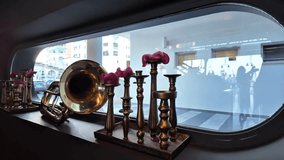 Elegant candle holders display, Shiny horn fixtures with city reflection, Charming vintage brass candle holders reflect cityscape through glass window with warm glow - Powered by Shutterstock - Get 15% off with code: PIKWIZARD15