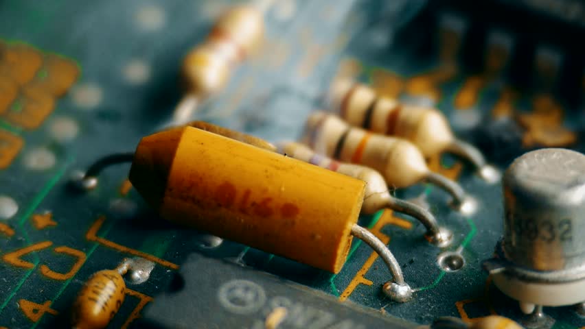 Extreme close-up of an electronic component exploding with bright sparks and electrical discharge. Short circuit and critical failure of computer hardware. High-energy electrical component malfunction