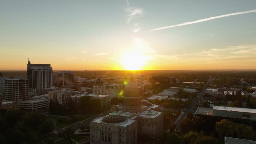 Idaho State Capitol Building and Boise cityscape with golden sunlight and sunflare