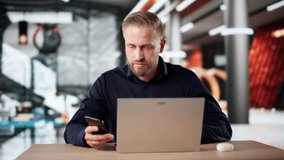 Man Using Phone To Send Voice Message While Working On Laptop - Powered by Shutterstock - Get 15% off with code: PIKWIZARD15